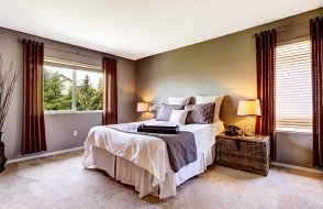 cozy bedroom with window treatments and carpet